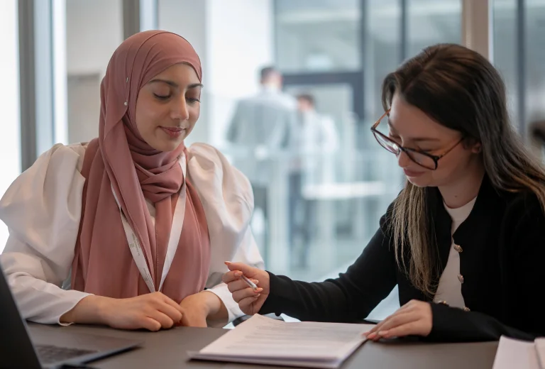 Two female Jones Day solicitors working together on document